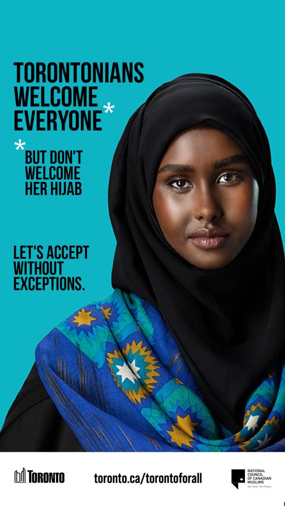 Torontonians welcome everyone. But don't welcome her hijab. Let's accept without exceptions. Woman in a black hijab with a blue background.