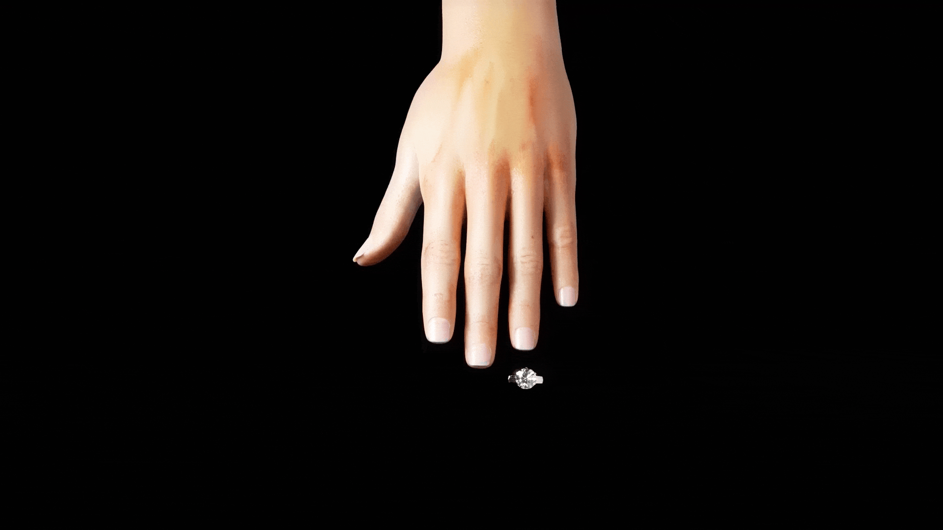 Animated gif of a hand with a People's diamond ring sliding on. The hand slides into a glove by Peoplest,the the diamond slides out of the ring slit in the glove.