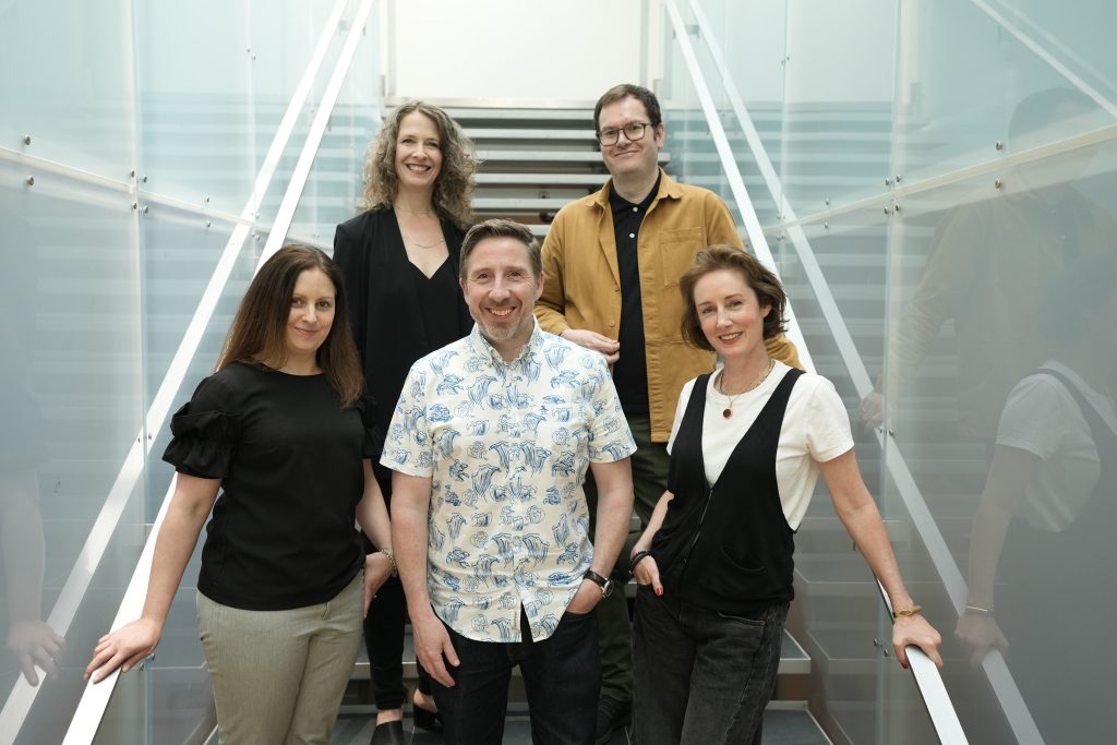 Rogers creative team of 5 posing on the stairs